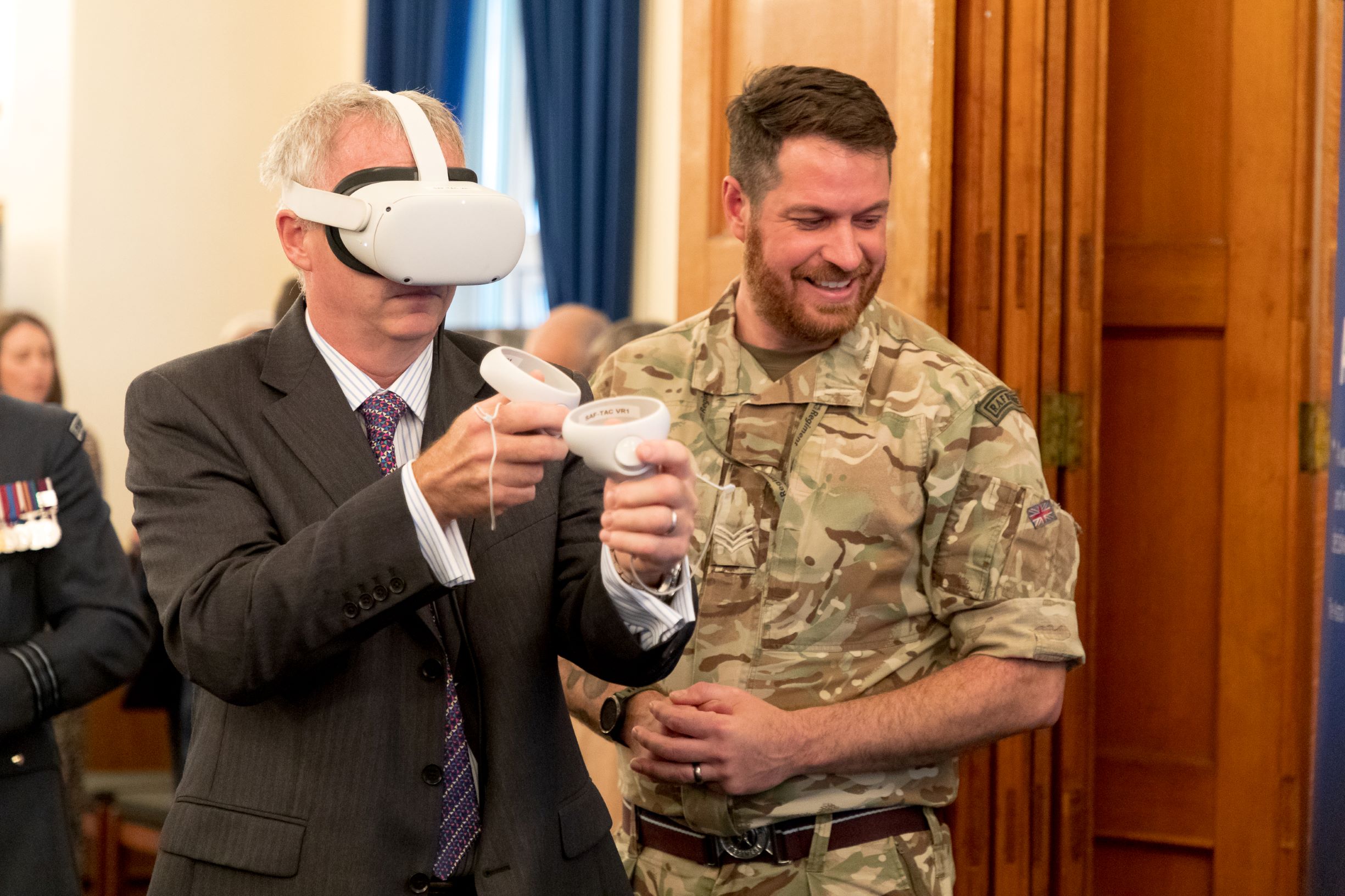 Image shows aviator and guest using Virtual Reality headset.